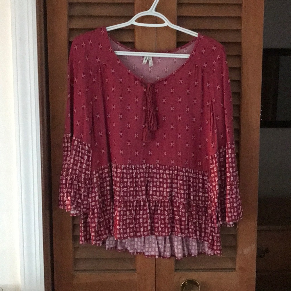 loose-fitting patterned blouse with bell sleeves